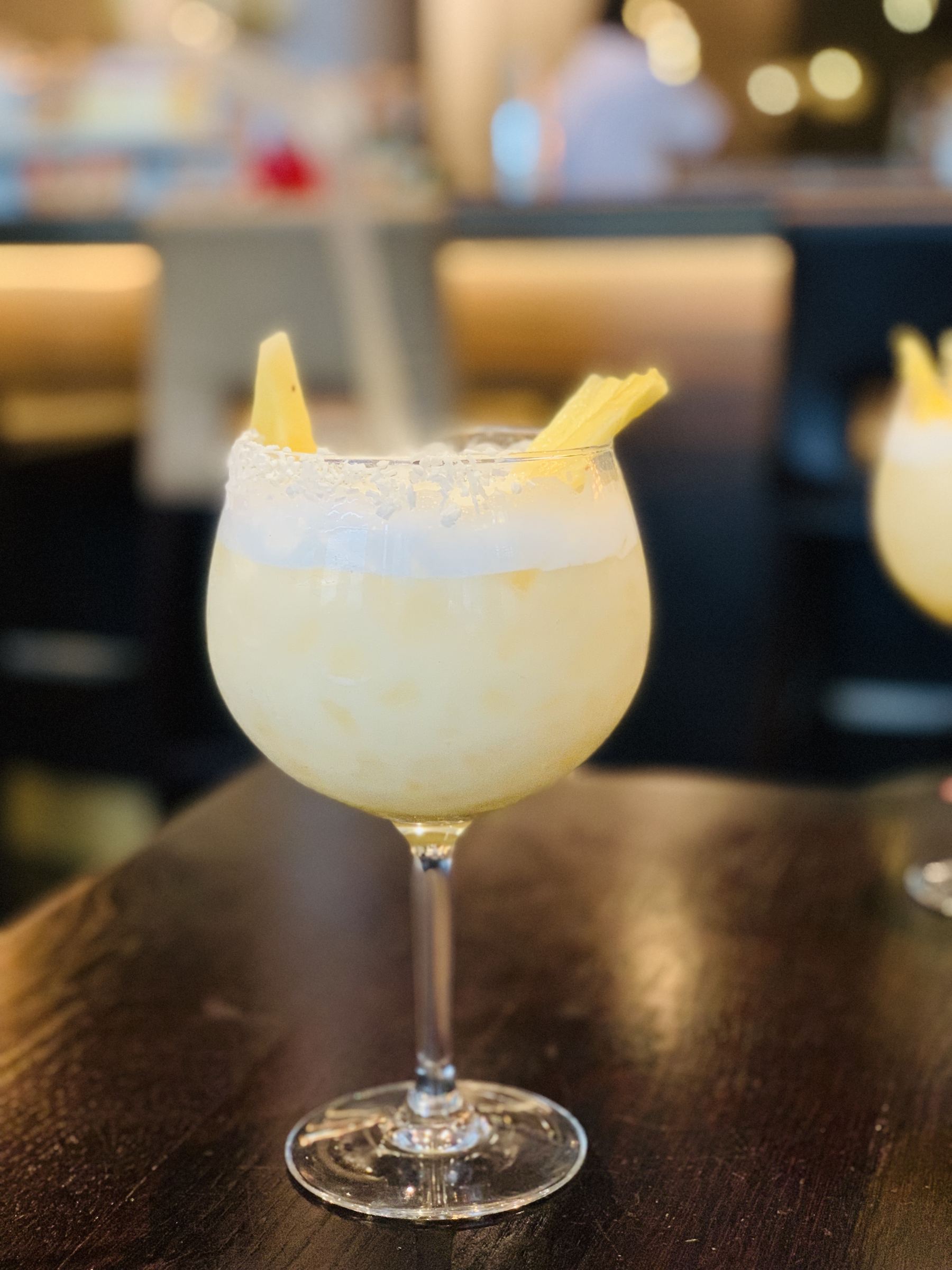 A frosted lemon drink in a stemmed glass